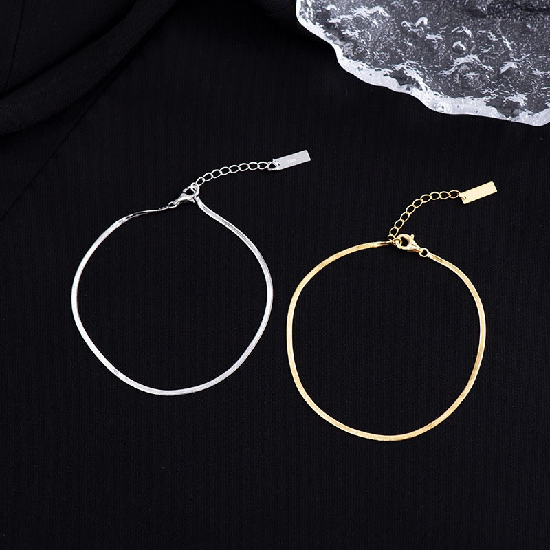 Close-up of sleek silver foot chain on ankle, part of wholesale foot jewelry bundle