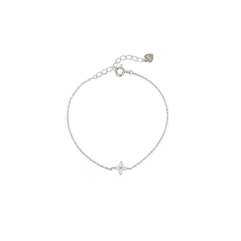 Vacation jewelry flat lay featuring beach themed anklet with clover charm