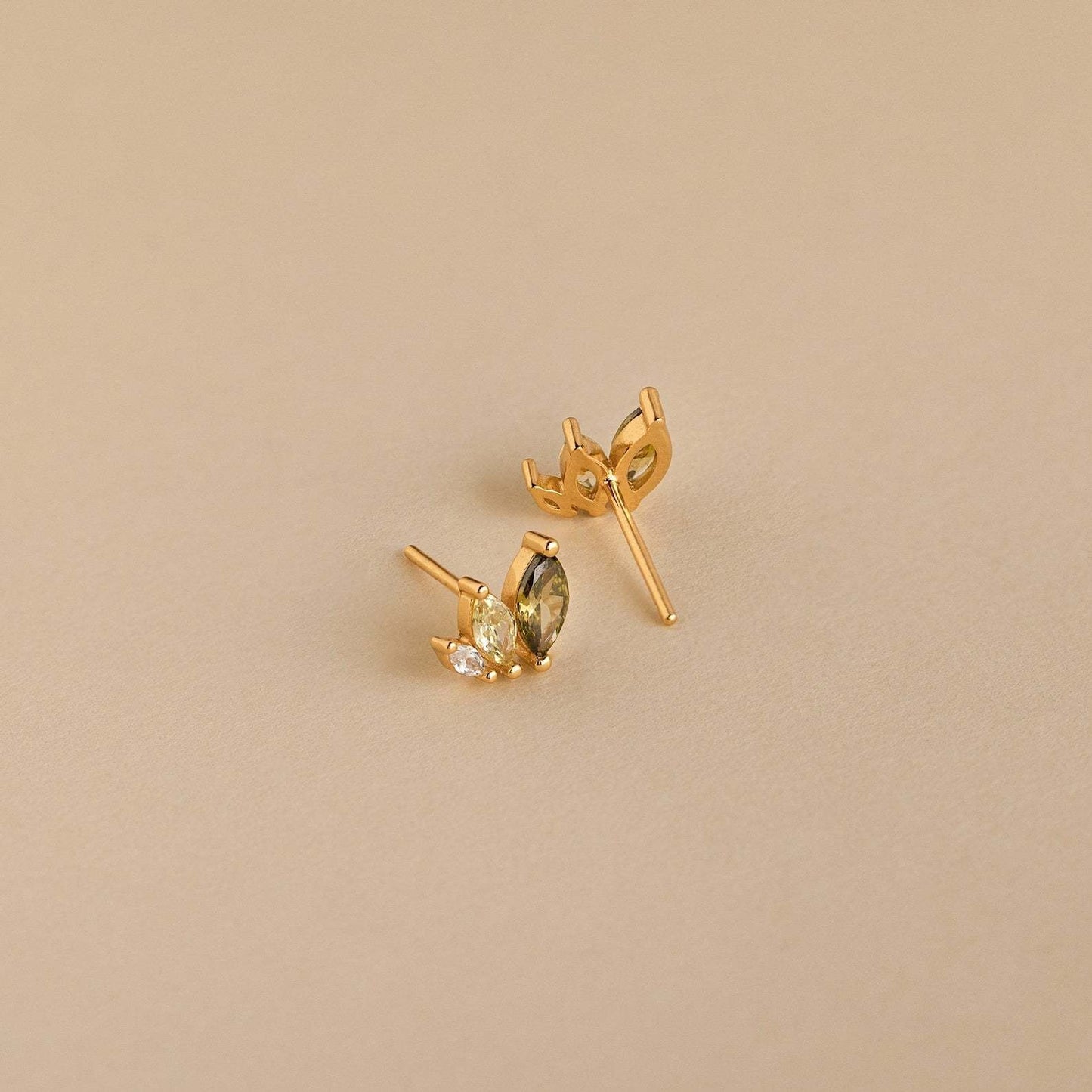 Close-up of gold marquise earrings with zircon sparkle, perfect for tropical outfits and summer beach jewelry collections