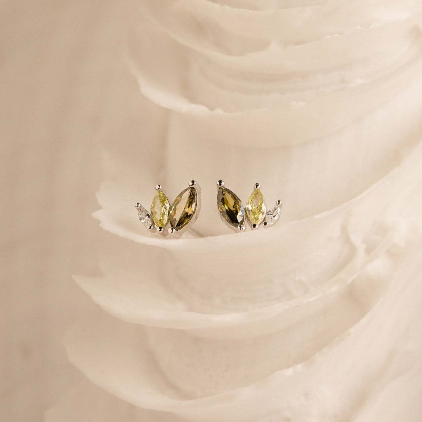 Dainty gold plated marquise CZ earrings on a natural fabric background, featured as lightweight summer beach jewelry