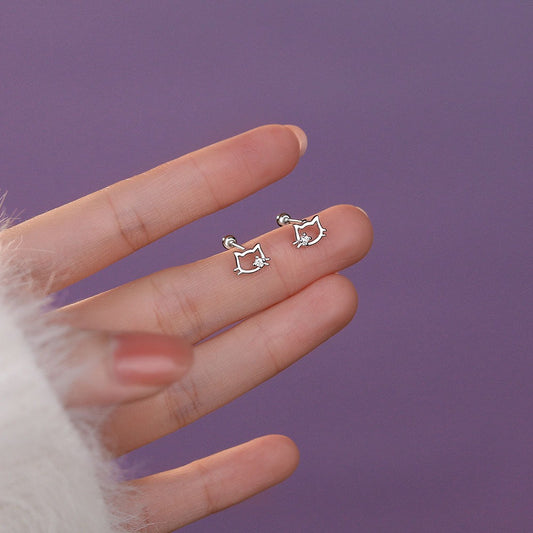 Sterling silver cat ear stud earrings with sparkling cubic zirconia, displayed on soft pink fabric for a festive gift look