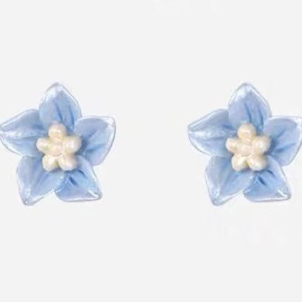 elegant handmade blue flower studs made of s925 silver, displayed on neutral background