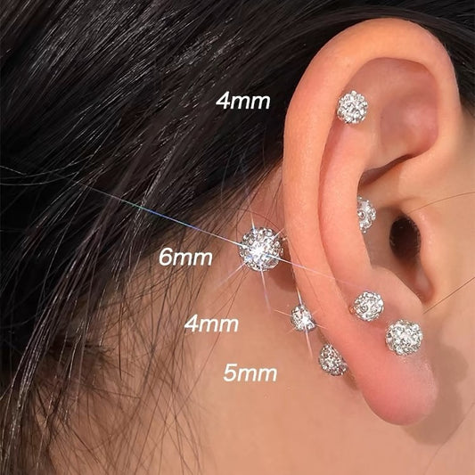 Elegant stud earrings set with faceted crystals, displayed on a neutral background for a clean jewelry presentation