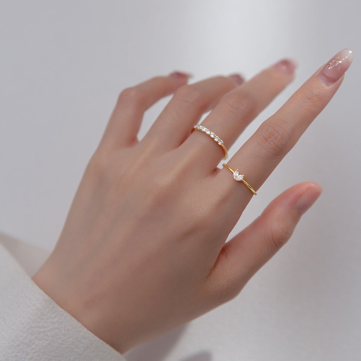 matching gold and silver friendship rings with heart and butterfly motifs