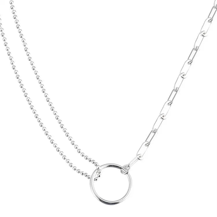 Close-up of sterling silver double ring necklace with delicate chain – asymmetrical fashion jewelry for everyday wear