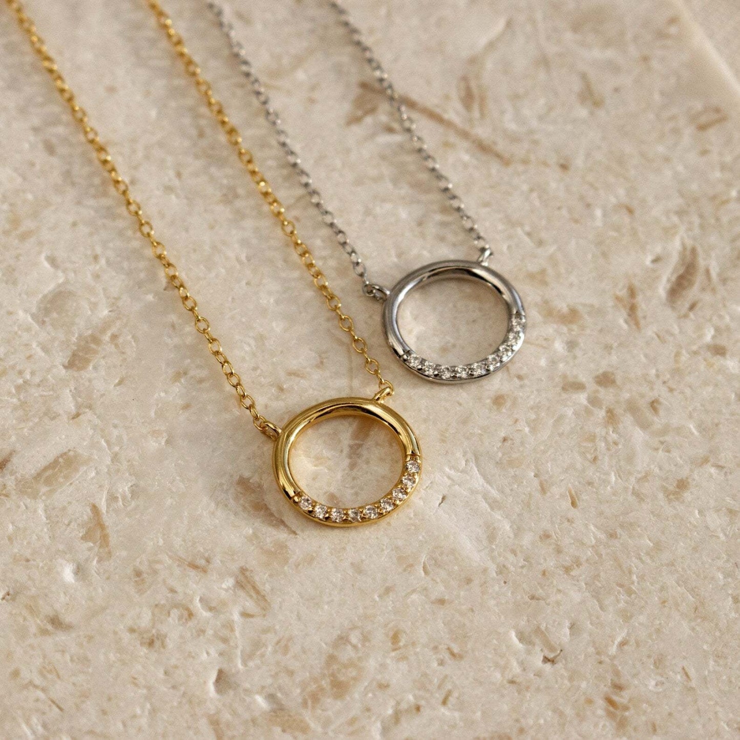Close up of sterling silver round pendant with sparkling CZ stone