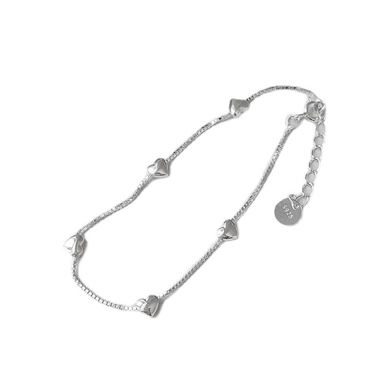 Stacked minimalist heart bracelets in sterling silver perfect for layering