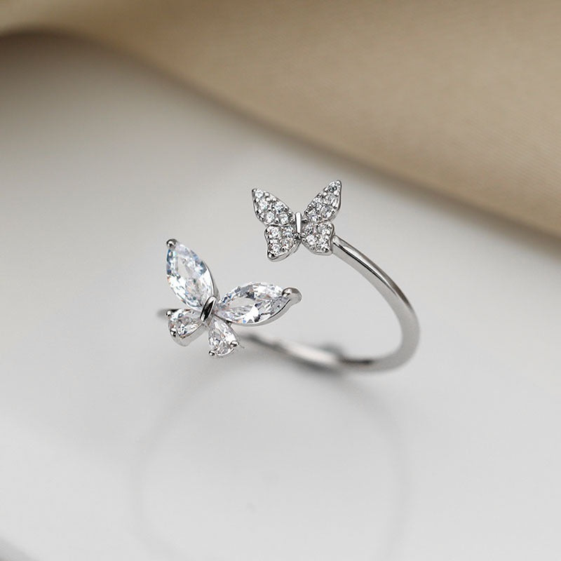 close-up of silver butterfly ring with pavé and marquise zircon detailing