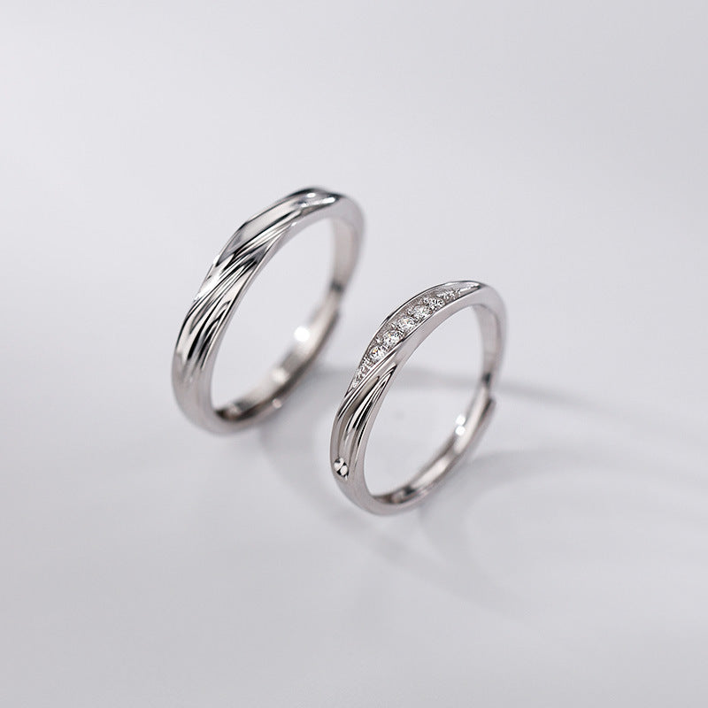 silver promise rings for couples with wave design and cubic zirconia stones