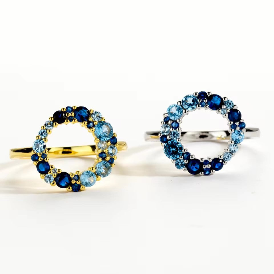 modern style silver engagement ring featuring a blue CZ gemstone