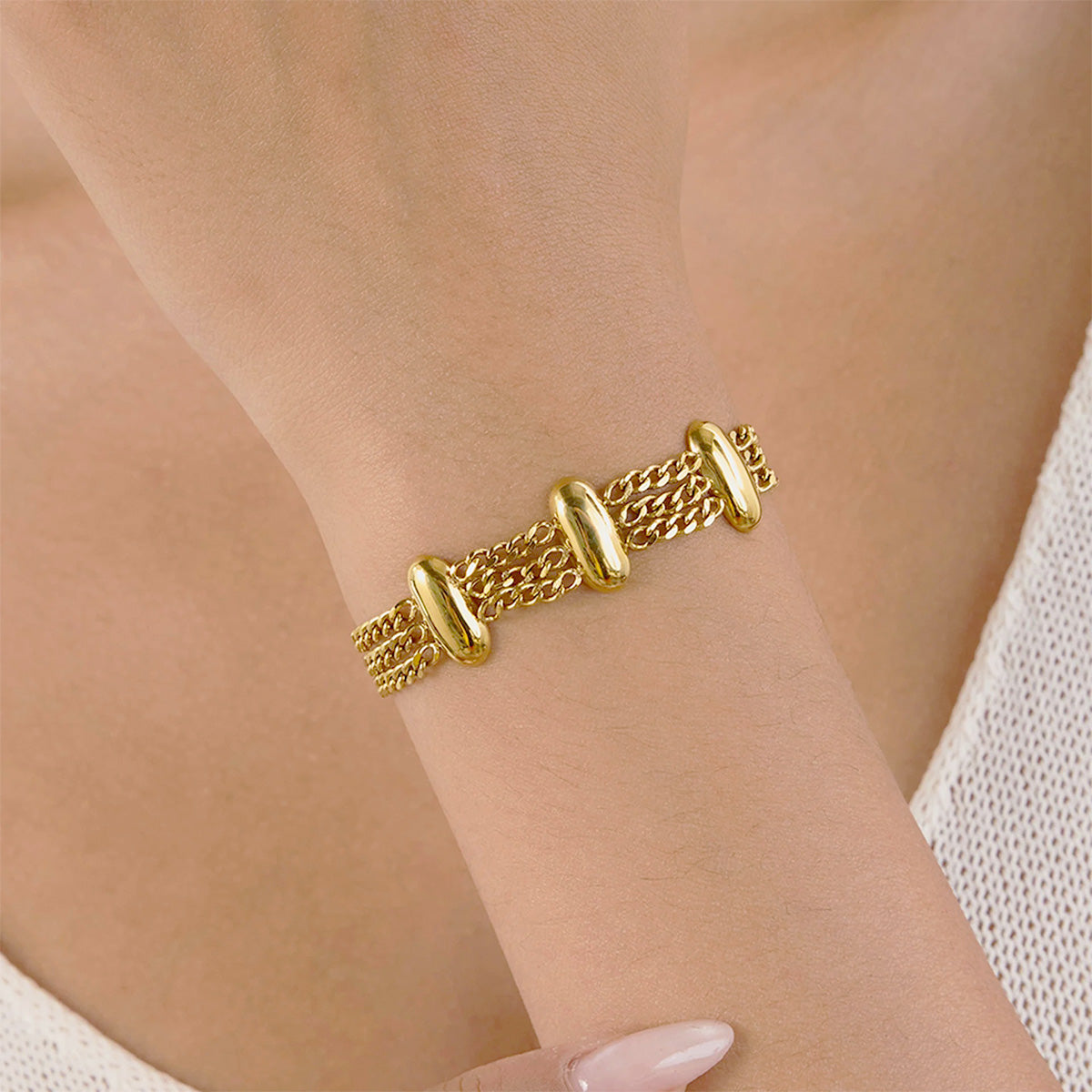 Model wearing a Layered Chain Gold Bracelet from a fashion jewelry set for women, showing the modern look of a stainless steel bracelet in gold finish.