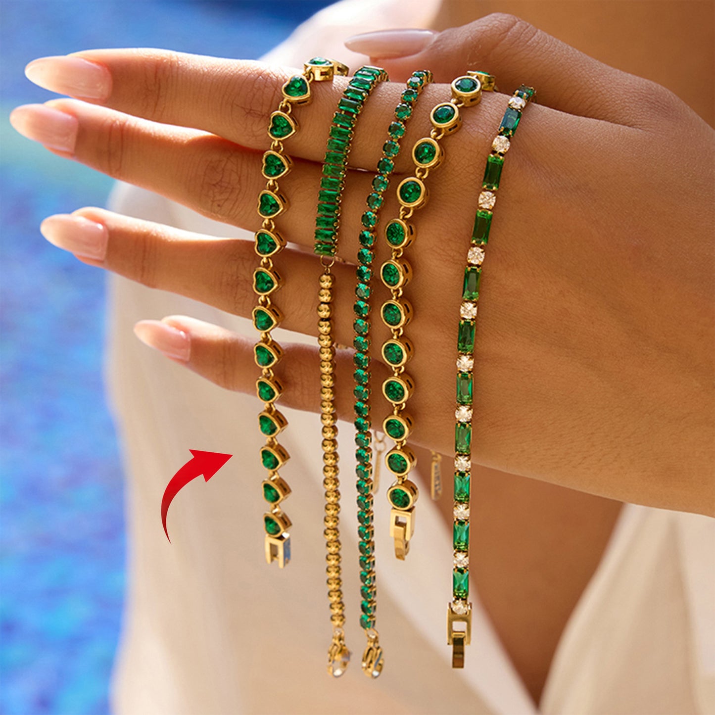 Model hand showcasing trendy stainless steel green heart bracelet set for women ideal for valentine jewelry and fashion accessory wholesale.
