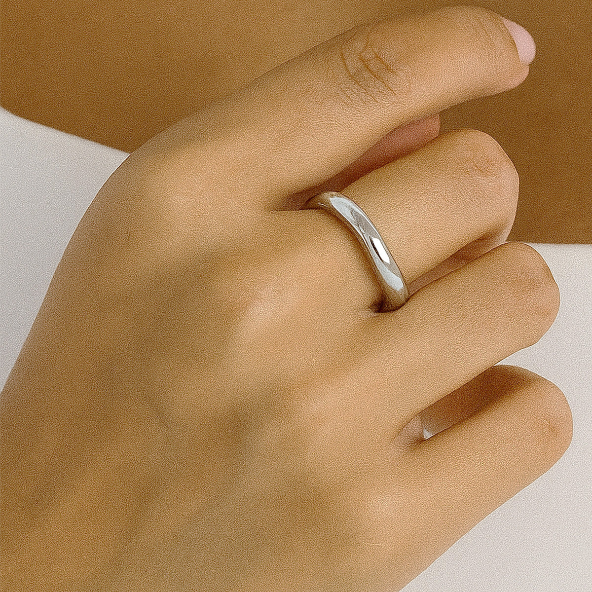 Minimalist silver stainless steel ring on woman's finger, showcasing a modern two tone ring design, perfect for everyday non tarnish fashion jewelry lovers.