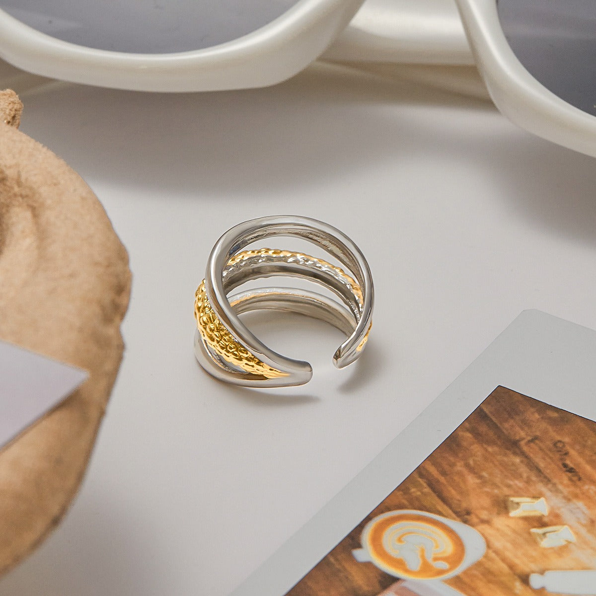 Model hand wearing two tone stainless steel ring with gold accent. Stylish gold and silver ring for women’s fashion and daily wear.