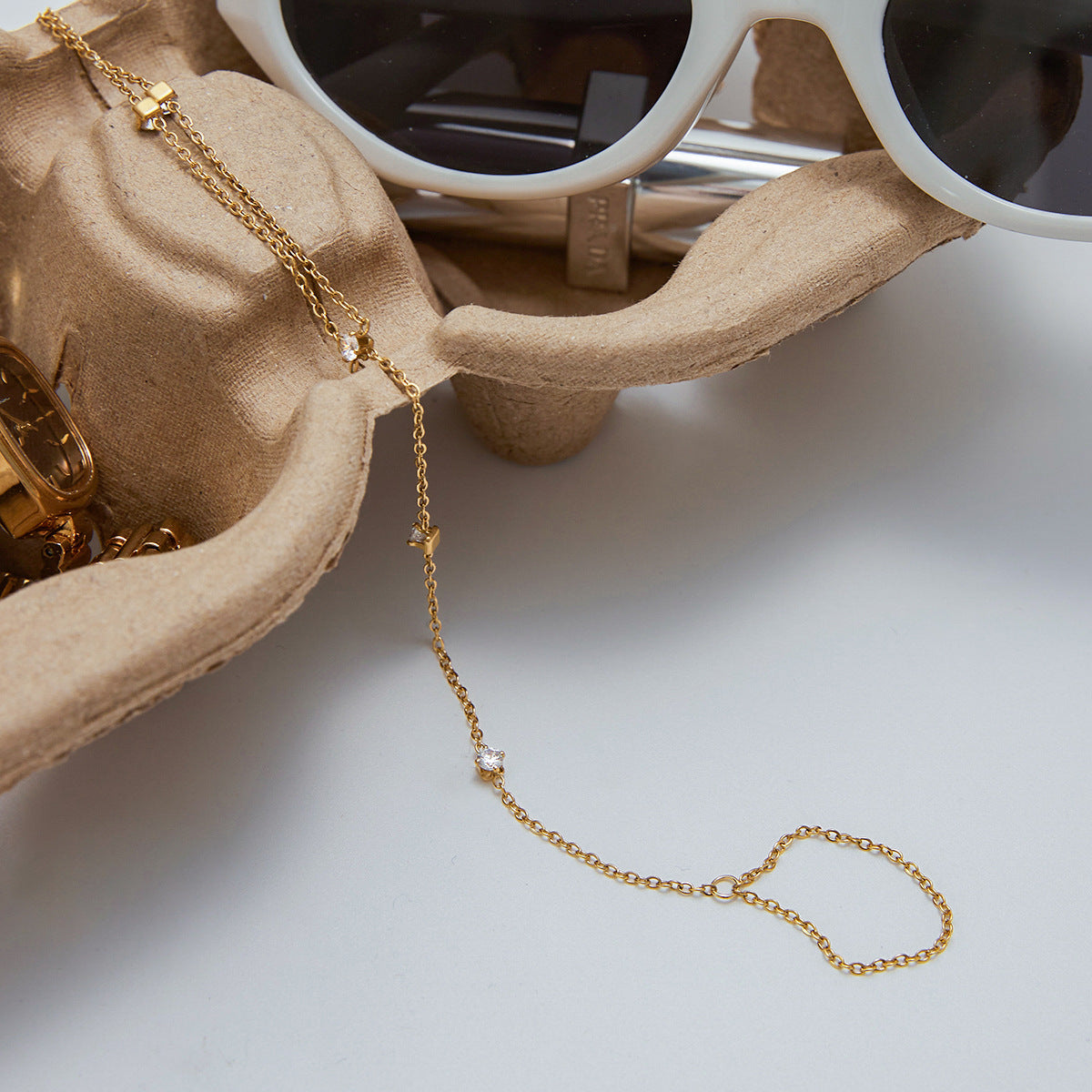 Dainty Gold Plated Stainless Steel hand chain bracelet for ladies with a Cubic Zirconia ring extension, ideal for wholesale fashion jewelry or gifting occasions.