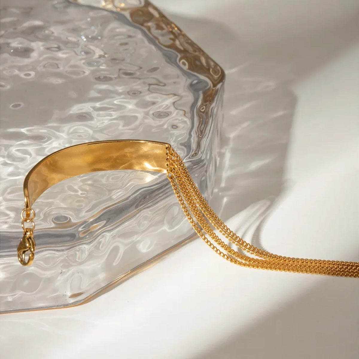 Stylish gold stainless steel bracelet for women with layered chains and a smooth centerpiece, ideal as a layered chain bracelet and trending gold chain link bracelet womens accessory.