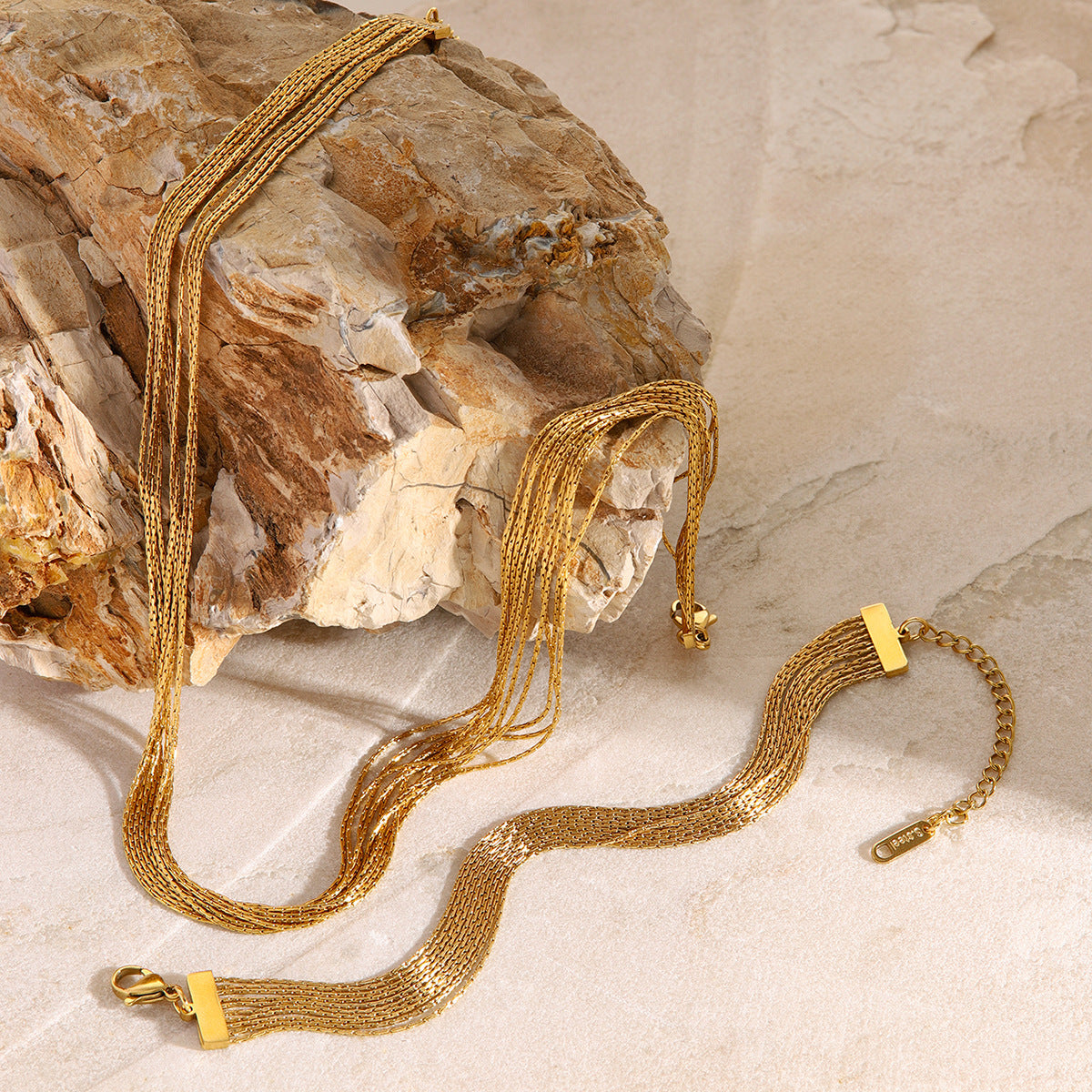 Close-up dimension view of the gold layered chain bracelet in stainless steel. Waterproof and hypoallergenic design, part of a trendy matching jewelry set for girls.