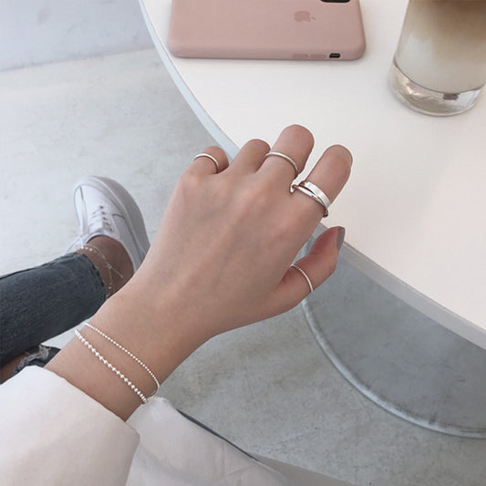 Lifestyle shot of double loop 925 silver ring for wholesale minimalist jewelry brands targeting Kpop and Korean style