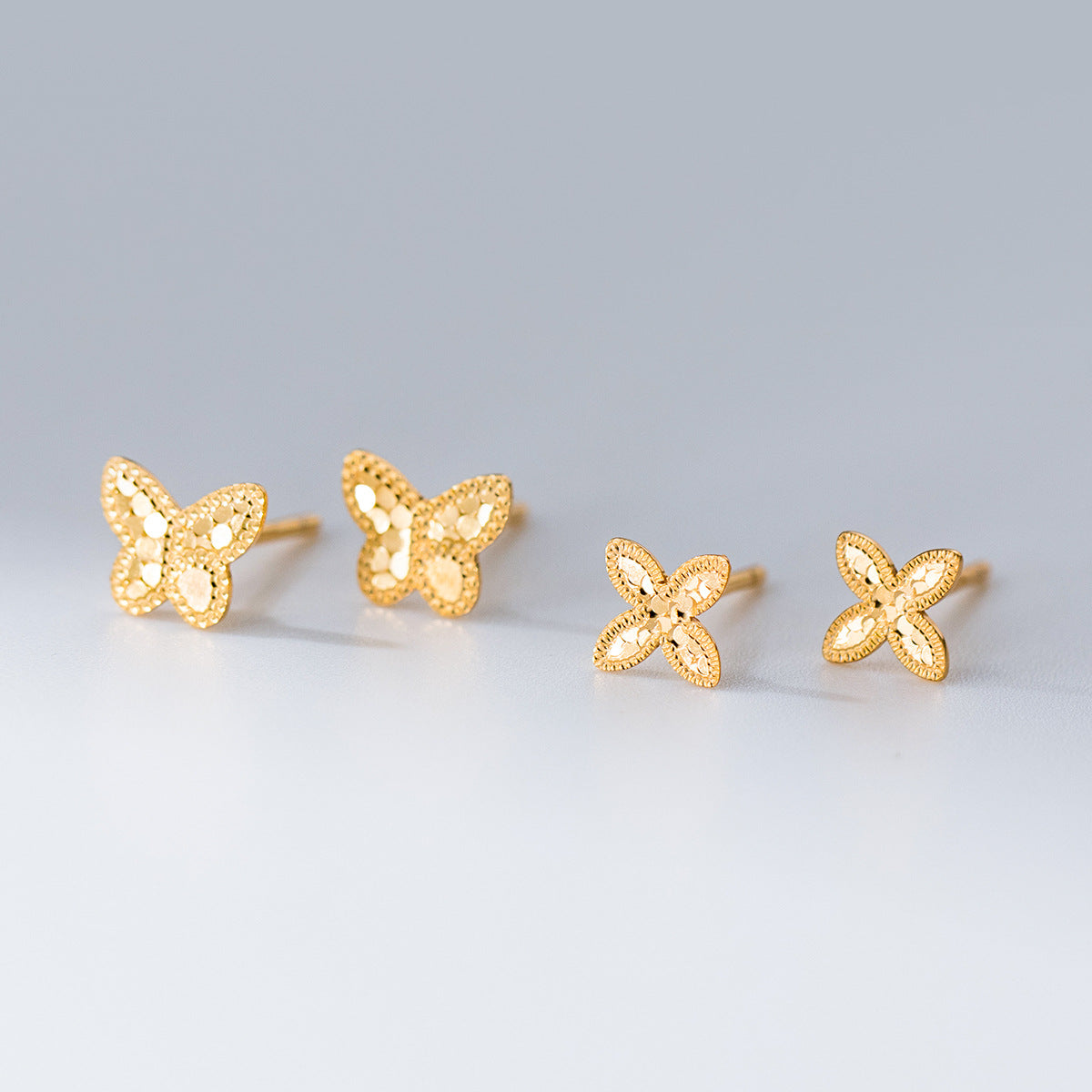 Wholesale 925 sterling silver butterfly and petal stud earrings in gold, laser cut hypoallergenic earrings for boutiques.