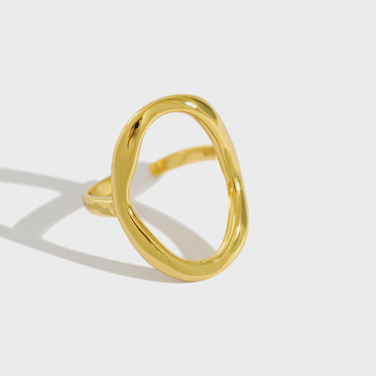 Close-up of a single 18k gold open oval ring on white background, featuring minimalist design made of 925 silver, ideal for wholesale minimalist jewellery suppliers.