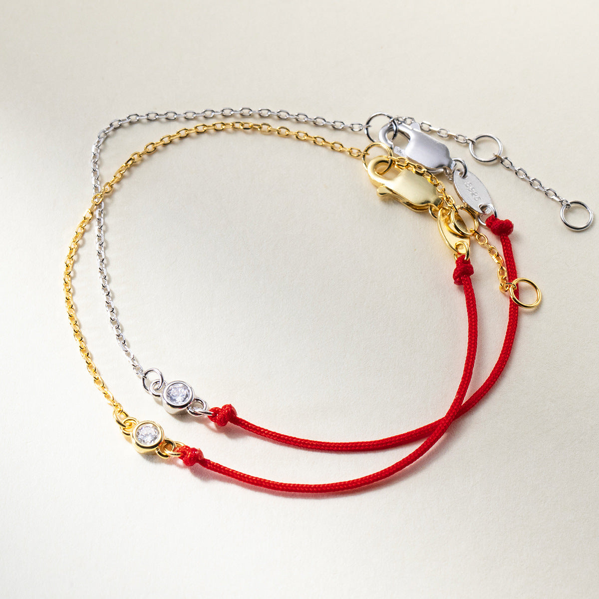 Minimalist 925 sterling silver and gold chain red string cubic zirconia bracelet set for wholesale jewelry suppliers.