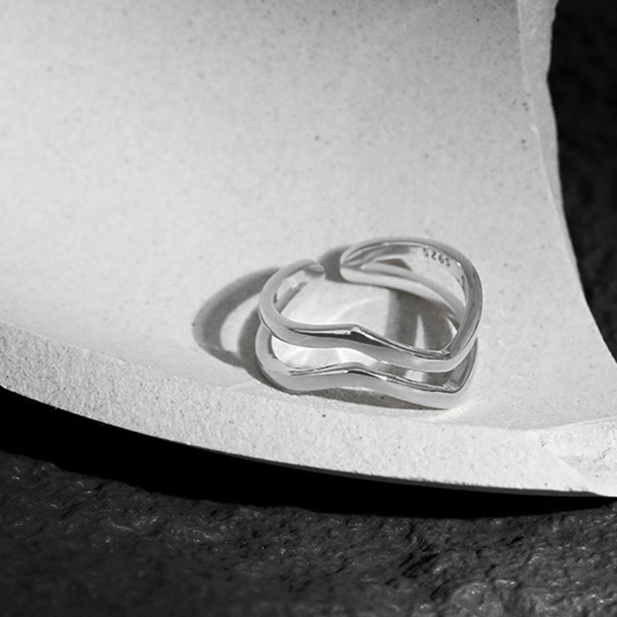 Close-up of 925 sterling silver wave ring with open end, ideal for minimalist jewelry wholesale collections.