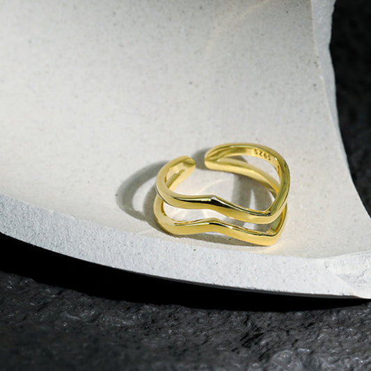 Gold-plated 925 silver wave ring on textured display, perfect for minimalist jewelry wholesale and 925 18k ring lovers.