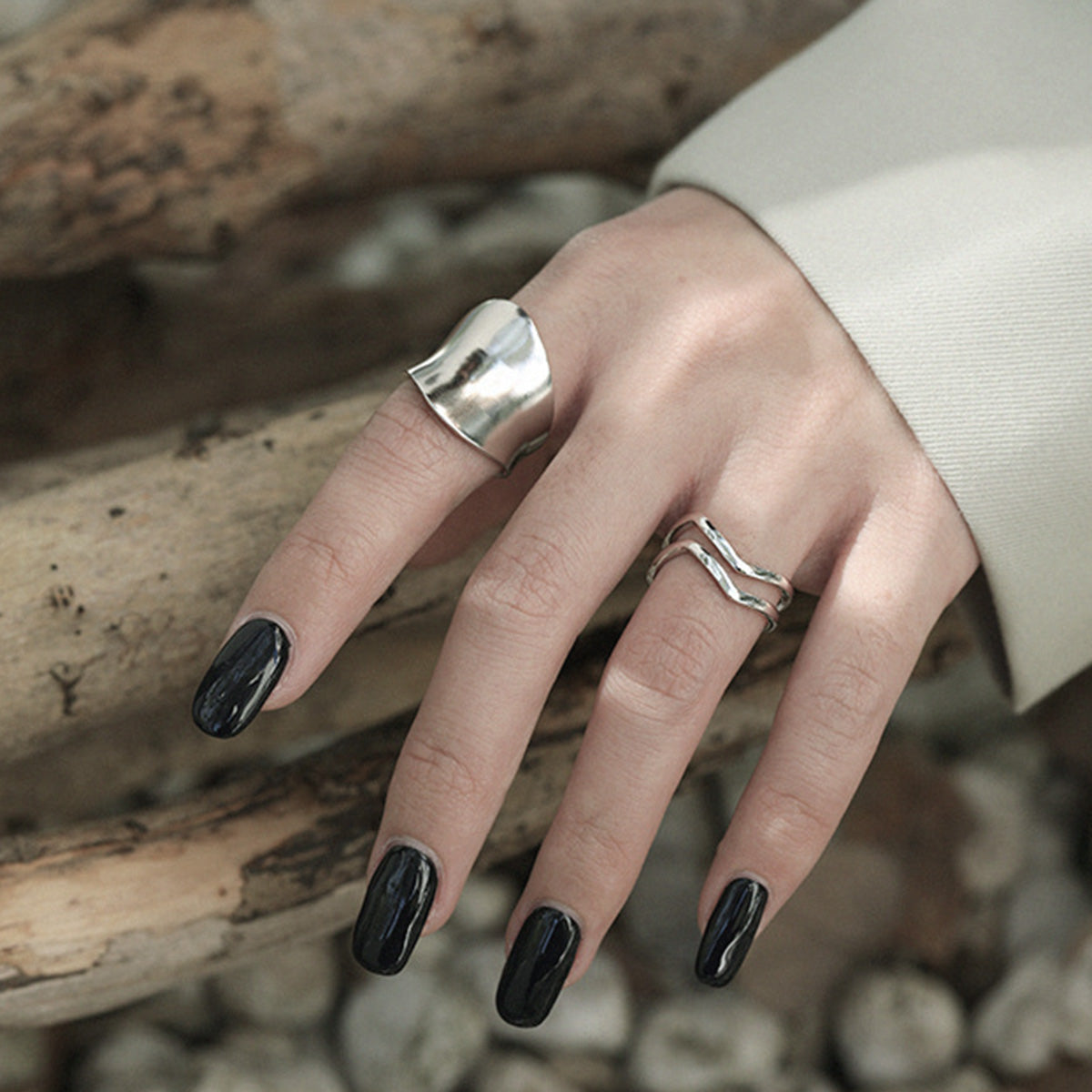 Silver wave ring styled with other minimalist rings, showcasing sterling silver everyday rings for wholesale boutiques.