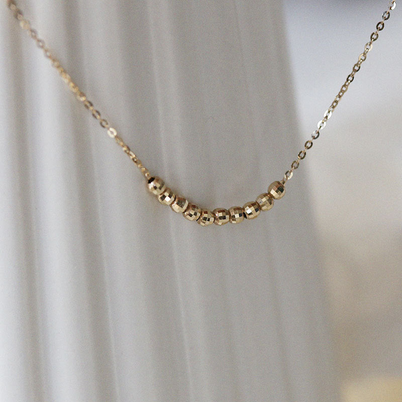 Close-up of 925 sterling silver 18K gold plated faceted bead necklace, wholesale silver jewelry and stylish collarbone chain design.