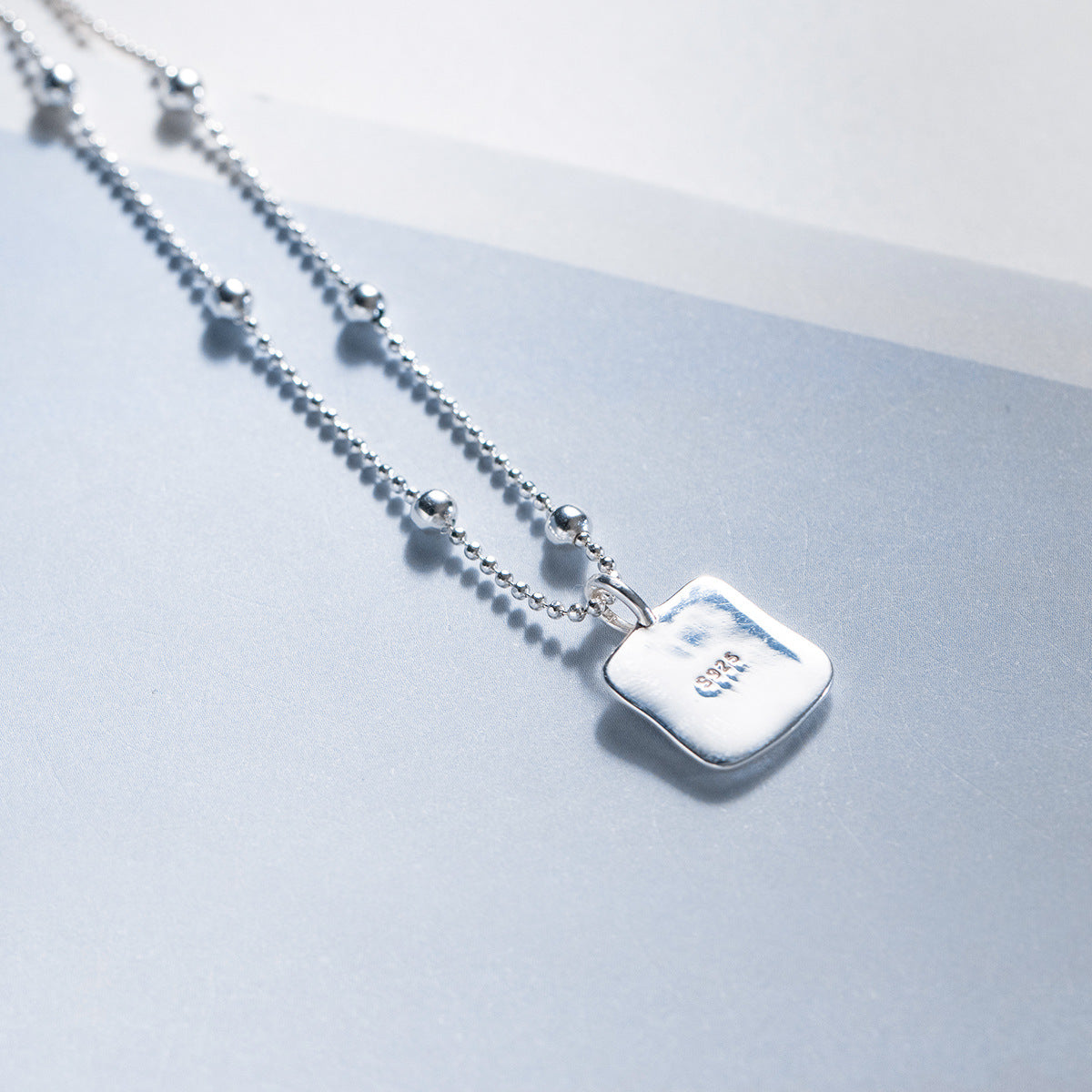 Back view of wholesale 925 silver black heart square pendant necklace showing 925 stamp
