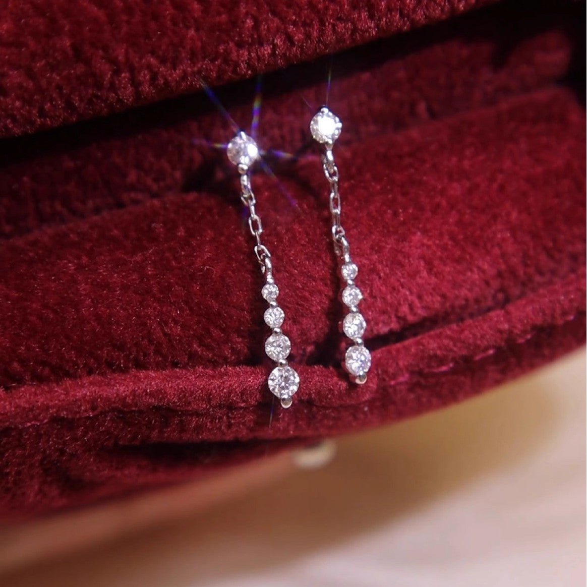 Pair of 18k white gold plated cubic zirconia chain drop dangle earrings displayed in a red velvet box, 925 sterling silver earrings wholesale.