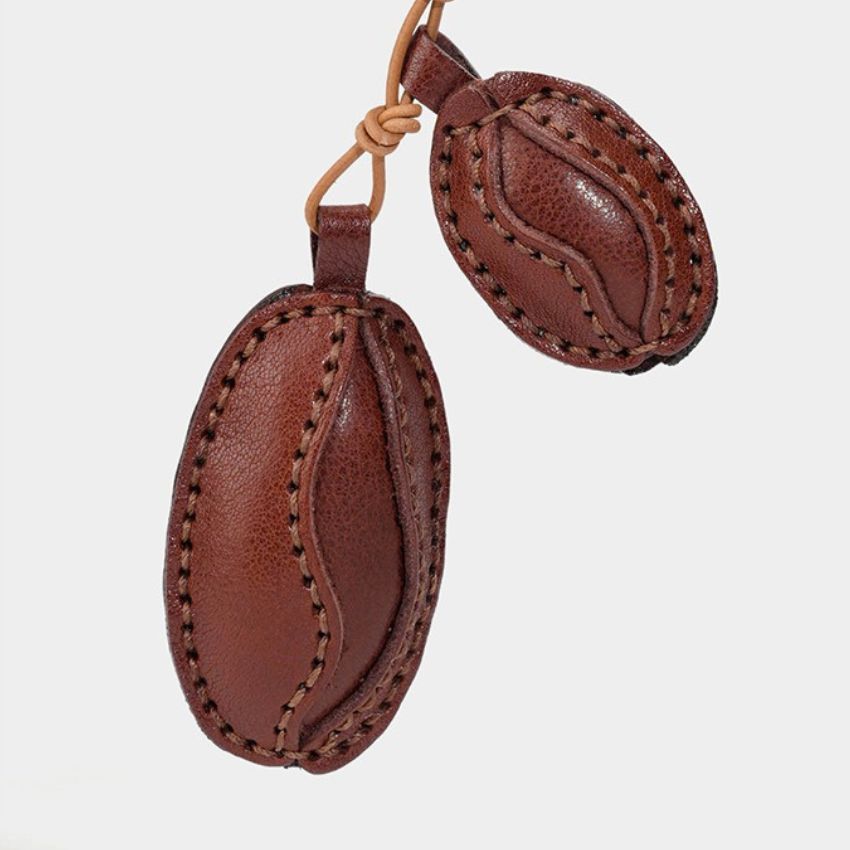 Brown leather coffee bean charm in two sizes with visible stitching