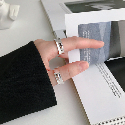 Hand wearing two geometric 925 sterling silver rings with mirror finish, showcasing minimalist rings for women in everyday wear style. Ideal for minimalist jewelry wholesale and geometric rings bulk orders.