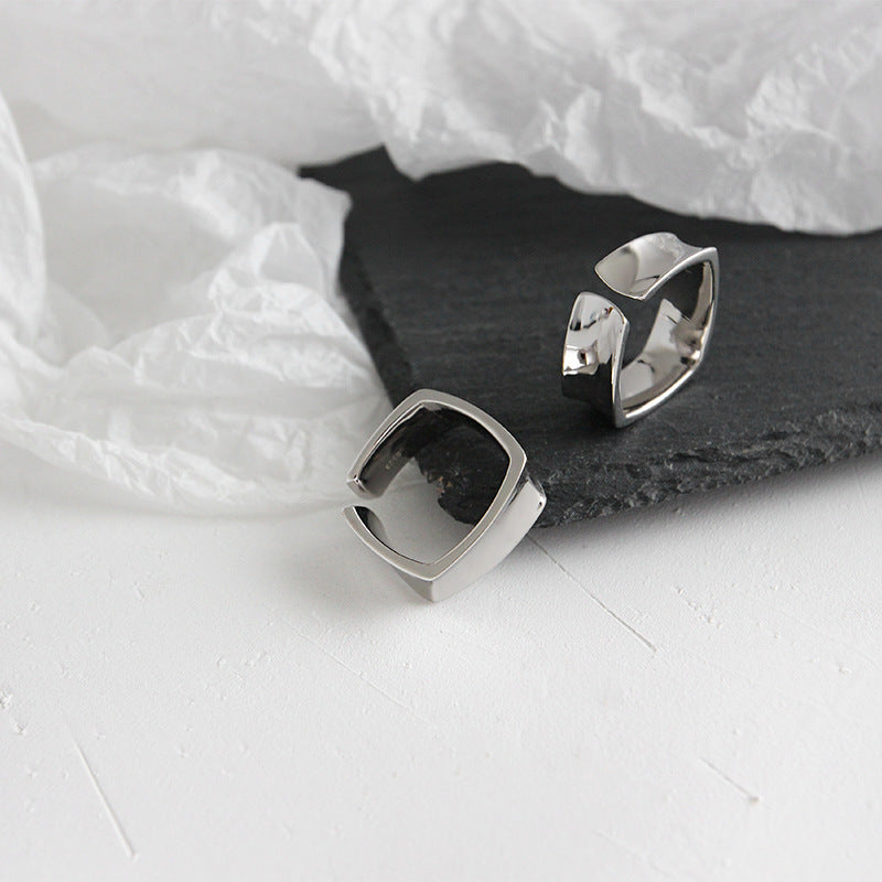 Two bold geometric open square 925 silver rings on textured background, highlighting the trendy ins style and perfect for silver minimal rings wholesale for retailers.