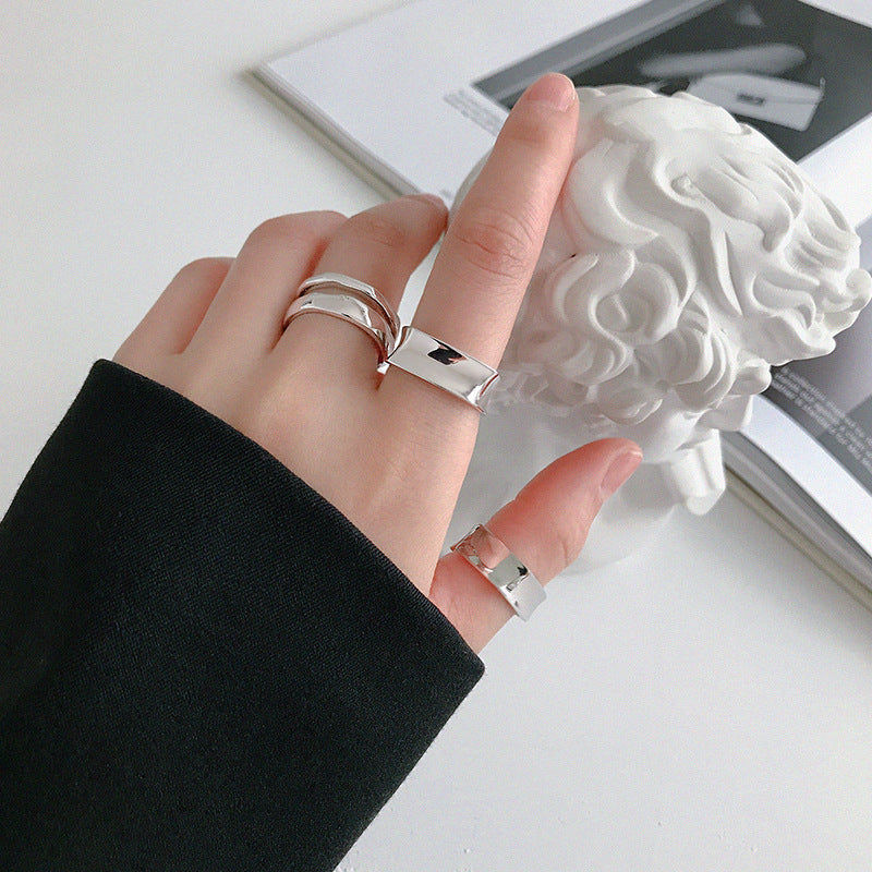 Multiple 925 silver minimalist rings stacked on hand in Korean ring style, perfect for kpop style rings and minimalist jewellery wholesale fashion boutiques.