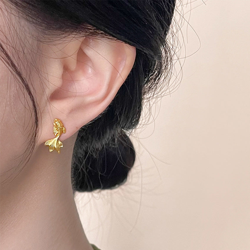 Model wearing gold koi fish earrings, lunar new year earrings brass jewelry wholesale
