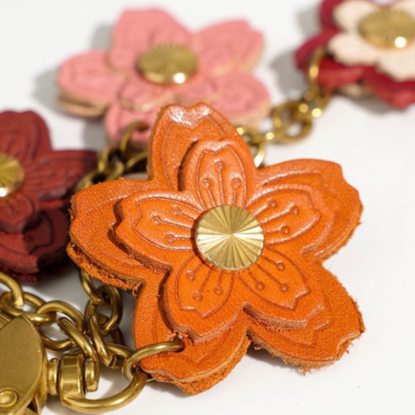 Close-Up of Genuine Leather Sakura Flower Charm – Handmade Gift Keychain with Gold Metal Details