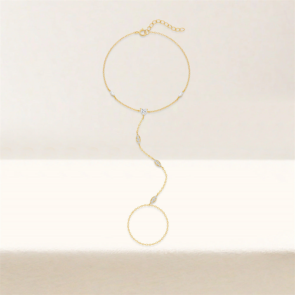 Minimalist gold finger bracelet set with marquise stones on a neutral background.