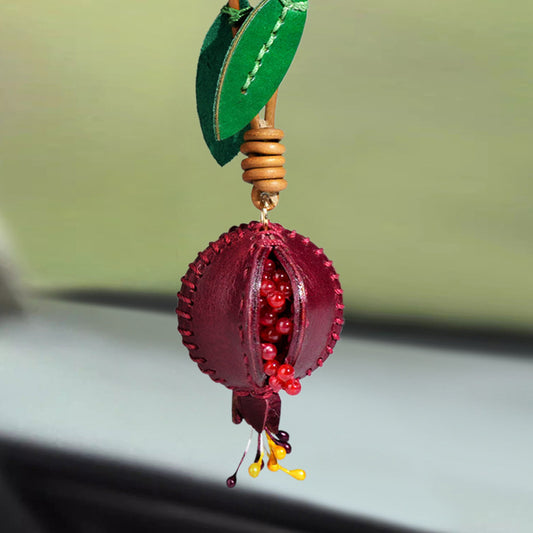 Pink handmade leather bag charm in fruit design, crafted from genuine leather with delicate stitching and leaf details, ideal as handbag decoration or car rearview mirror charm for boutiques and bag charm wholesale buyers.