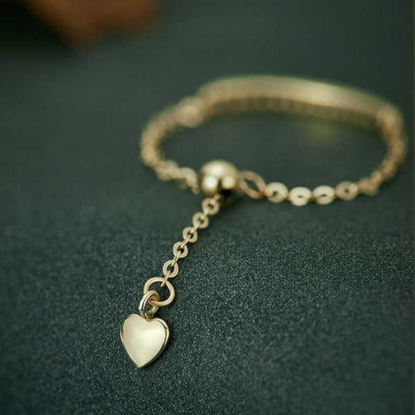 Adjustable sterling silver chain ring with zircon bar and heart charm detail