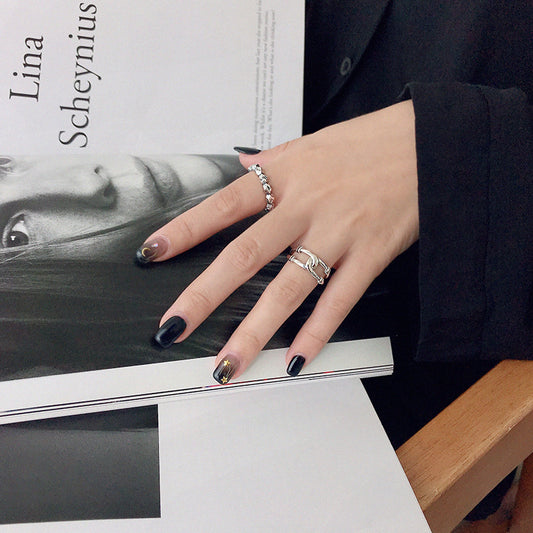 Sterling silver vintage ring set displayed on a wooden cone for minimalist jewelry wholesale presentation