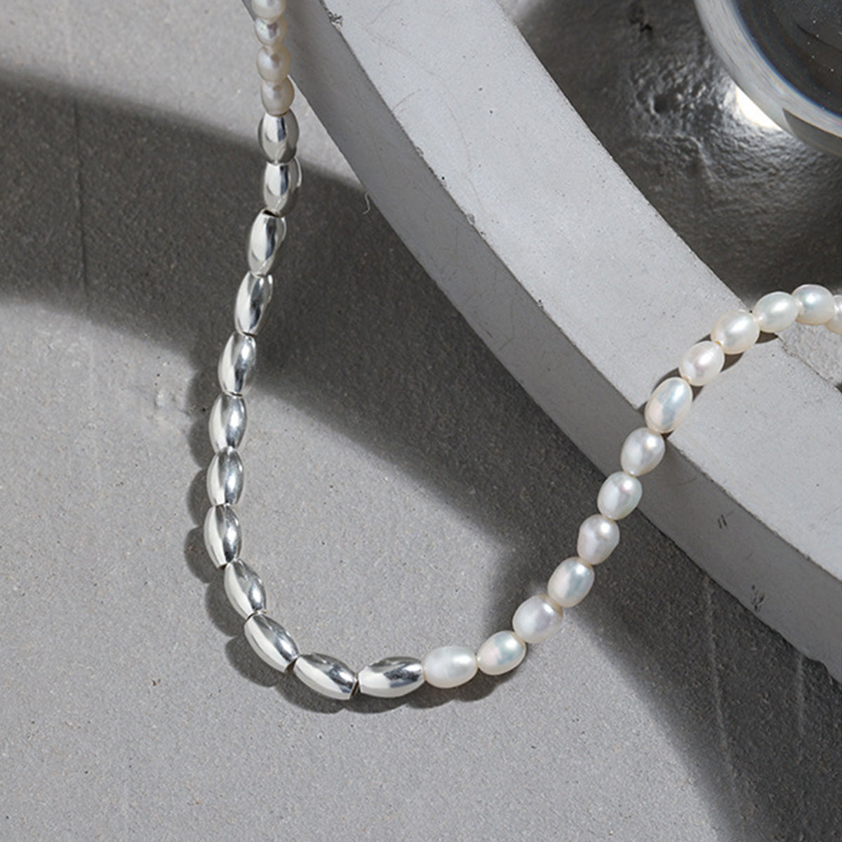 Close-up of silver rice beads and natural freshwater pearls on an S925 sterling silver necklace, perfect for wholesale and ins style jewelry collections.