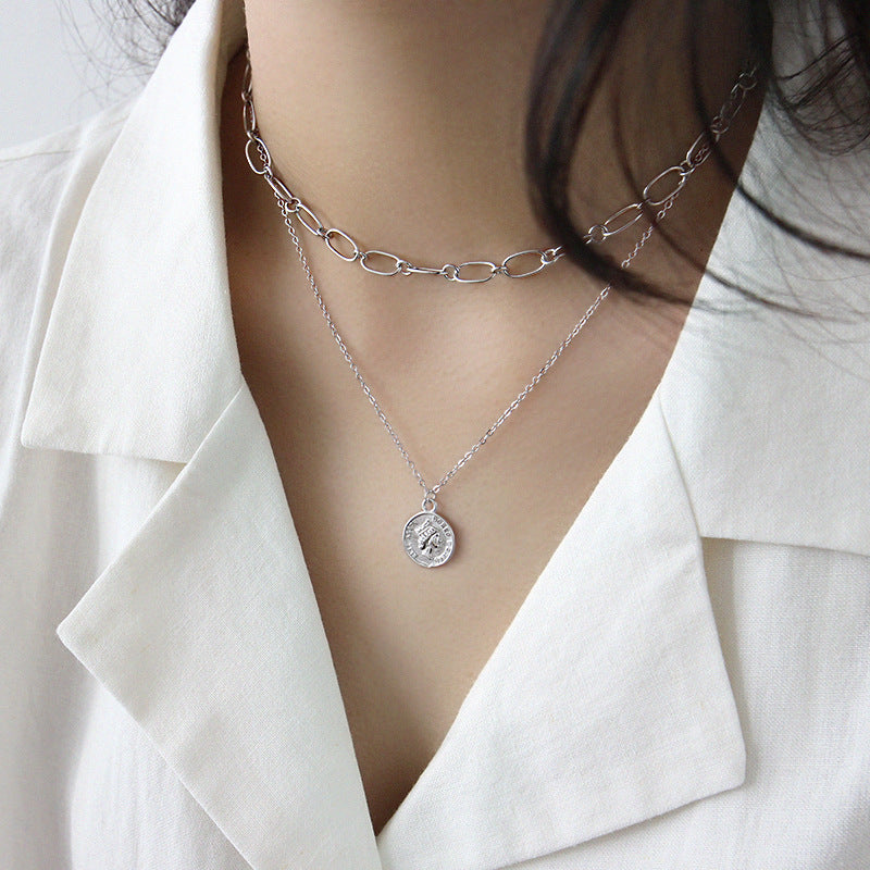 Silver vintage coin portrait pendant necklace styled with layered minimalist jewelry wholesale