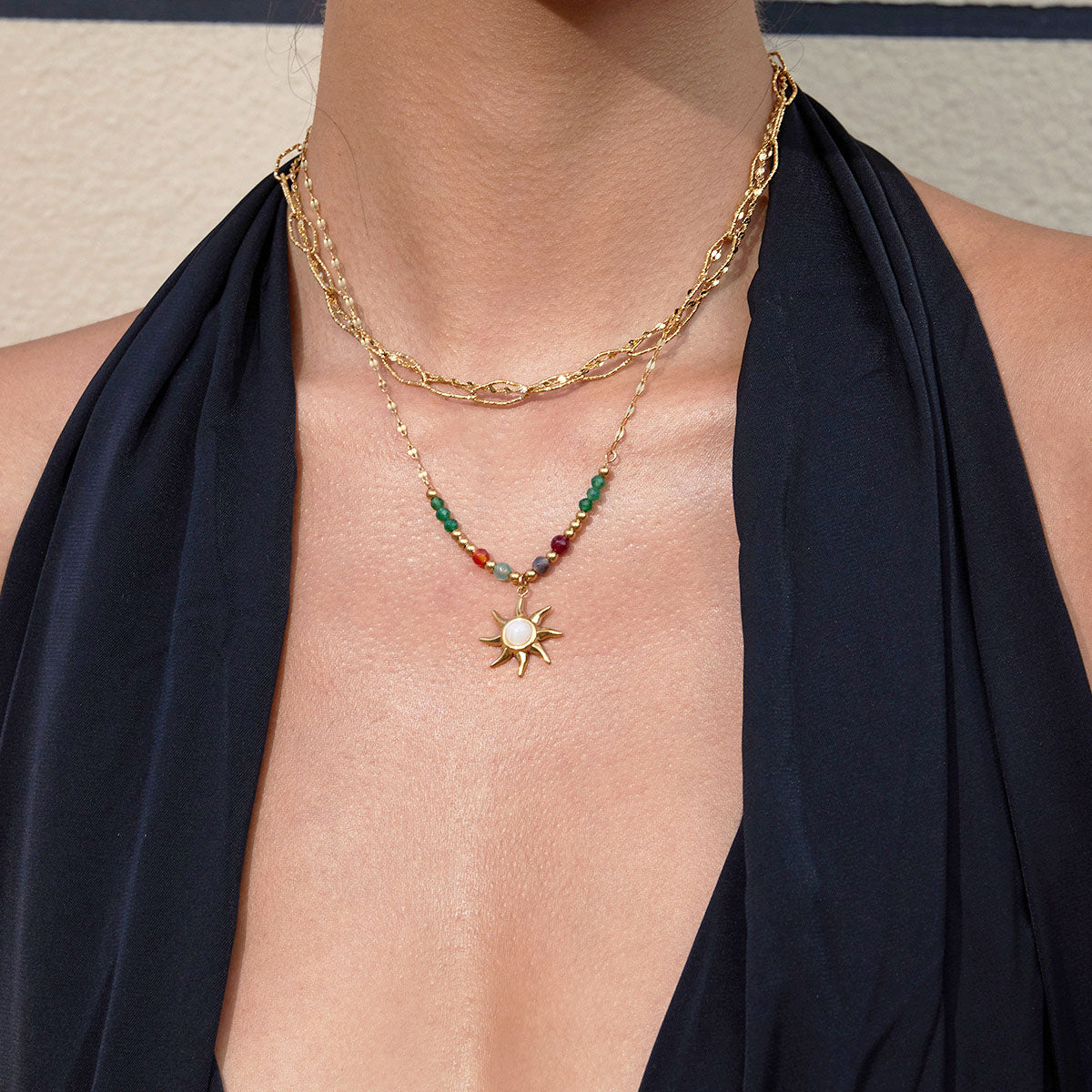 Layered colorful beaded sun charm necklace featuring stainless steel chain for beach fashion jewelry