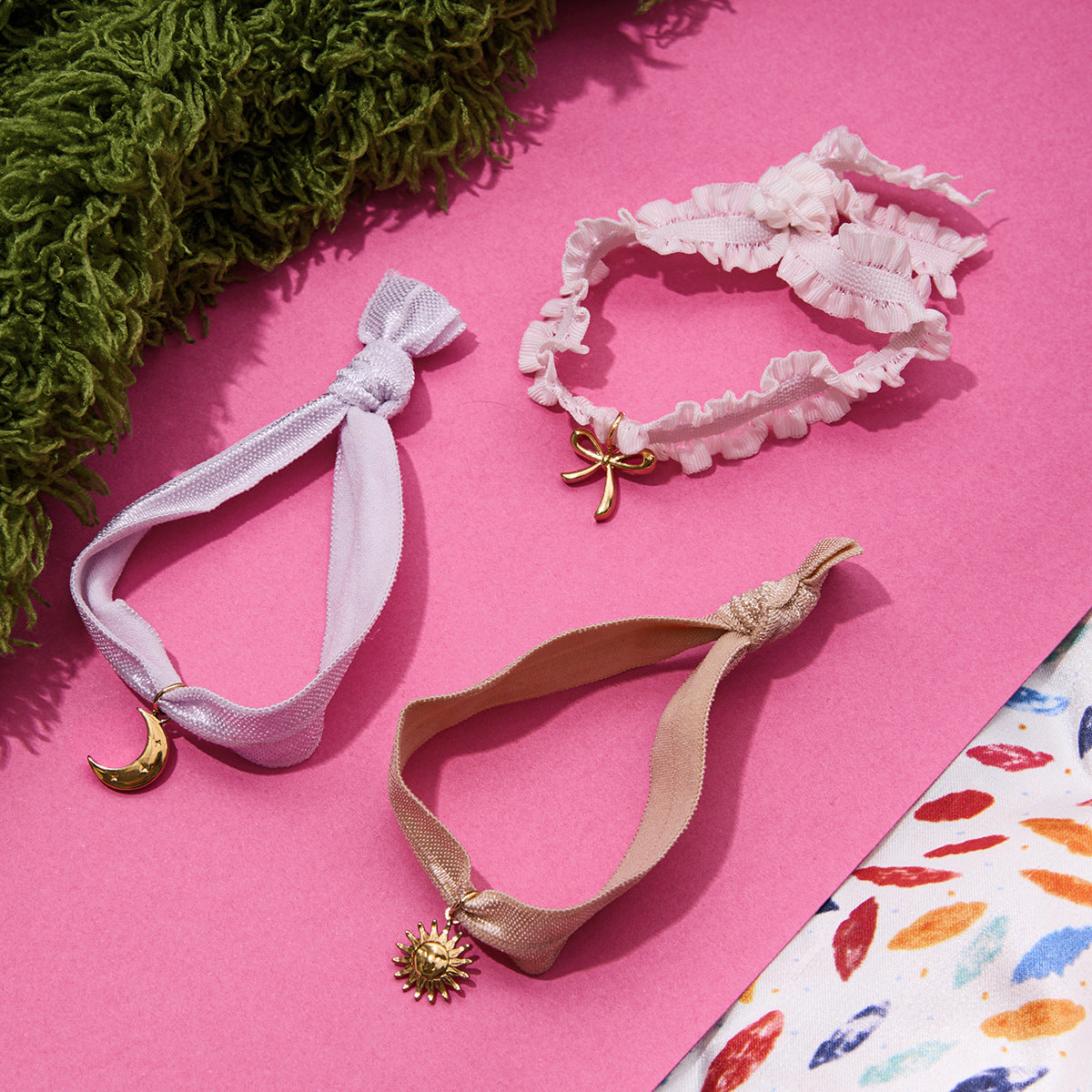 Wholesale coquette style ribbon bracelets set with gold stainless steel sun, moon, and bow charms for fashion jewelry retailers