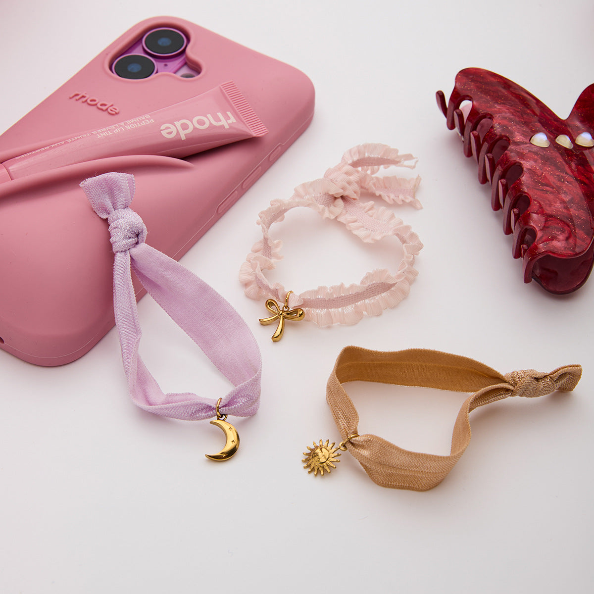 Aesthetic stainless steel ribbon bracelets with gold charms styled for TikTok and boutique wholesale jewelry collections