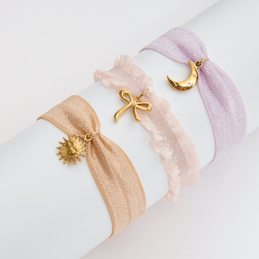 Adjustable coquette ribbon bracelets with stainless steel sun, moon, and bow charms, ideal for minimalist wholesale jewelry lines
