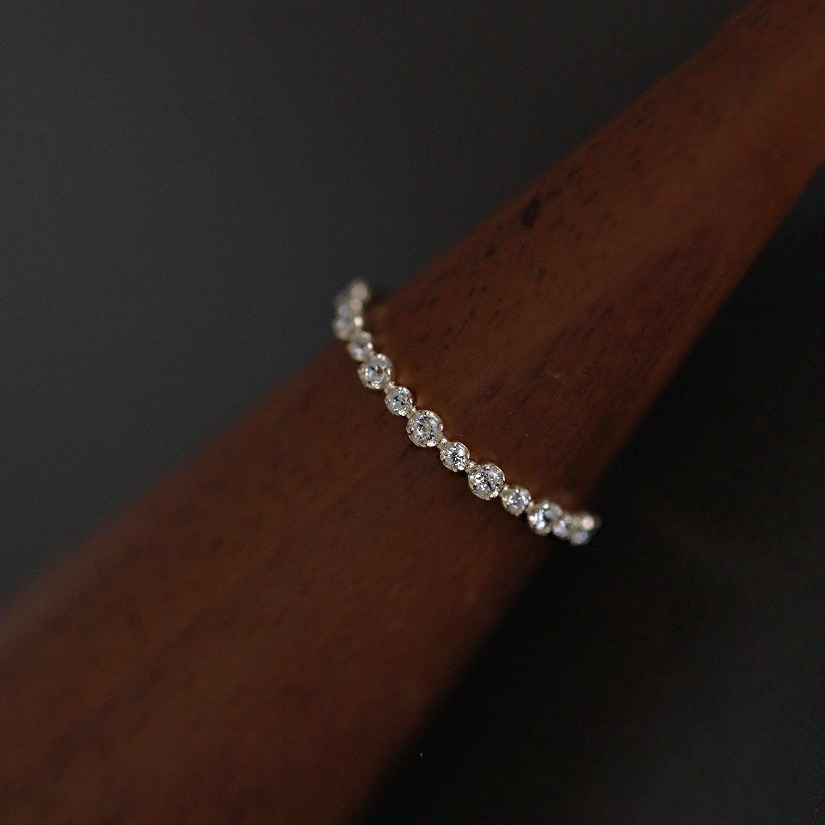 Close up of 14K gold plated sterling silver ring featuring a row of sparkling zircon stones