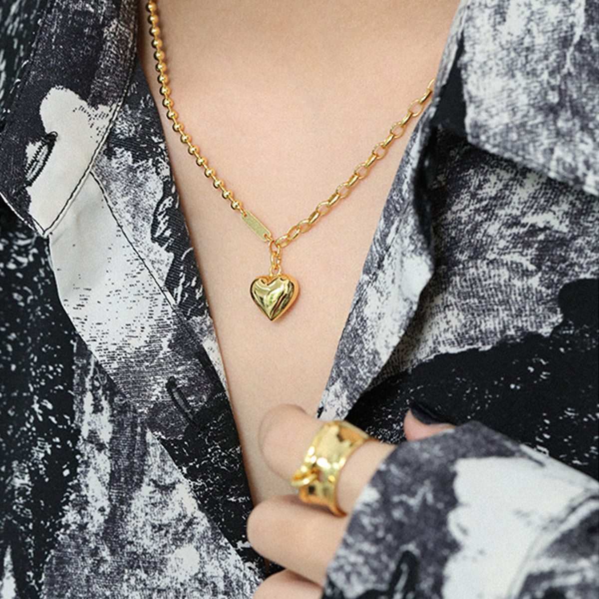Gold heart necklace styled with chunky link chain, popular among womens gold heart necklace wholesale collections.