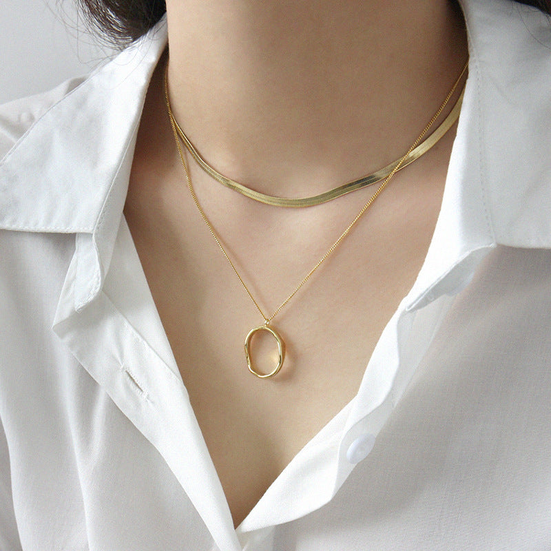 Model wearing gold irregular oval pendant necklace layered with choker, wholesale 925 silver jewelry for everyday wear